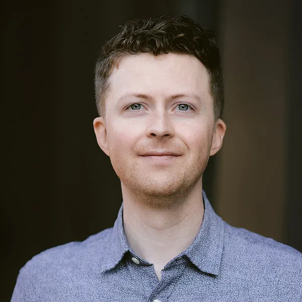 A close up of a person wearing a blue shirt.